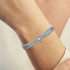 1/10 CT. T.W. Diamond Crossover Bangle Bracelet in Sterling Silver or 14K Gold Over Silver